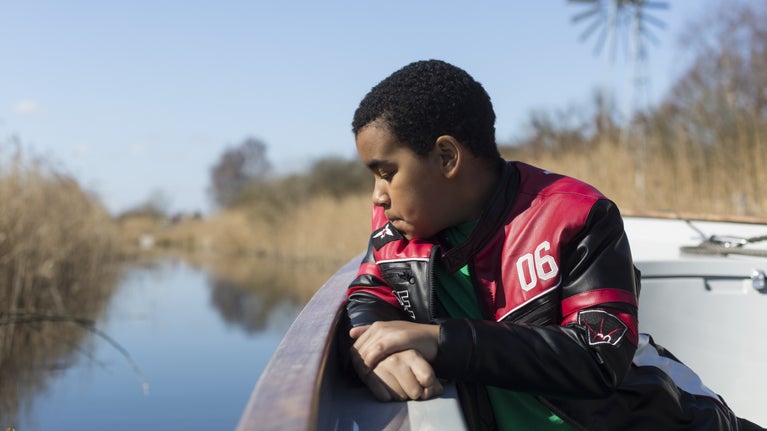 A visitor on a boat ride at Wicken Fen National Nature Reserve, Cambridgeshire